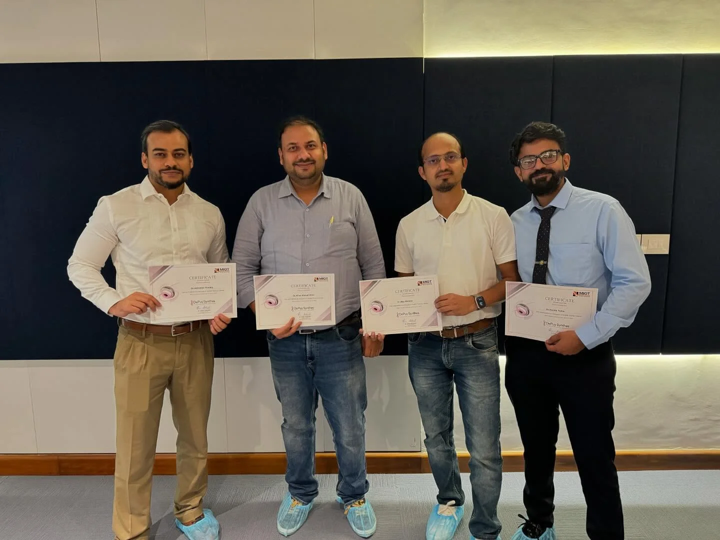 Dr. Abu Akrama receiving a DePuy Synthes course certificate at MIOT Hospital, with three fellow surgeons